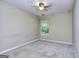A bright bedroom with neutral carpet and a ceiling fan at 5640 Terremont Cir, Norcross, GA 30093