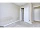 Neutral bedroom featuring a closet with white folding doors and soft carpet flooring at 5640 Terremont Cir, Norcross, GA 30093