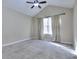 Bright, carpeted bedroom with a ceiling fan and large window at 5640 Terremont Cir, Norcross, GA 30093