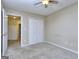 Carpeted bedroom featuring a ceiling fan and double door closet at 5640 Terremont Cir, Norcross, GA 30093