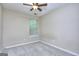 A bedroom with neutral carpet, a ceiling fan, and a window at 5640 Terremont Cir, Norcross, GA 30093
