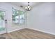 Bright dining area with chandelier, large window, and a door to the outside at 5640 Terremont Cir, Norcross, GA 30093