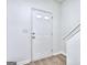 A bright entryway with a white door and wood-look flooring at 5640 Terremont Cir, Norcross, GA 30093
