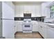 Fully equipped kitchen with modern appliances and tiled backsplash at 5640 Terremont Cir, Norcross, GA 30093