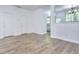 Open-concept living area with hardwood floors, white walls, and natural light at 5640 Terremont Cir, Norcross, GA 30093