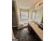 Bathroom features include brown tile flooring, soaking tub, and a long vanity at 11657 Flemming Ct, Hampton, GA 30228