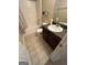 Practical bathroom features a shower-tub combo, neutral floor tiles, and essential fixtures at 11657 Flemming Ct, Hampton, GA 30228