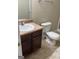 Modest bathroom with vanity, mirror, toilet, and outdated flooring at 11657 Flemming Ct, Hampton, GA 30228