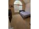 Cozy bedroom with a large arched window that offers natural light and neutral color palette at 11657 Flemming Ct, Hampton, GA 30228