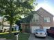 Beautiful brick home with a two-car garage and landscaped front yard, shaded by a mature tree at 11657 Flemming Ct, Hampton, GA 30228