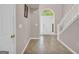 A bright foyer featuring neutral walls, tiled floors, white trim, stairs and front door at 11657 Flemming Ct, Hampton, GA 30228