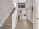 Spacious foyer featuring neutral walls, carpeted stairs and an opening to another room at 11657 Flemming Ct, Hampton, GA 30228