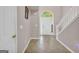 Bright foyer with arched doorway, tiled floor, and staircase at 11657 Flemming Ct, Hampton, GA 30228