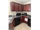 Well-maintained kitchen featuring dark cabinetry, neutral walls, and tile flooring at 11657 Flemming Ct, Hampton, GA 30228