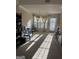 Sun-drenched living room with carpet flooring, large windows, and light-colored walls at 11657 Flemming Ct, Hampton, GA 30228