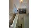 Carpeted staircase with a white banister in an open entryway with a vaulted ceiling and decorative lighting at 11657 Flemming Ct, Hampton, GA 30228