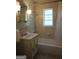 Bathroom with shower and tub combination, vanity, mirror, and window offering natural light at 1381 Ne Normandy Ne Dr # 4, Atlanta, GA 30306