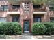 Charming brick apartment building with green door and meticulously maintained landscaping at 1381 Ne Normandy Ne Dr # 4, Atlanta, GA 30306