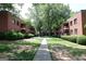 Scenic view of a tree-lined walkway between brick apartment buildings providing a peaceful community setting at 1381 Ne Normandy Ne Dr # 4, Atlanta, GA 30306