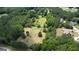 Aerial view of a sprawling property surrounded by lush trees, showcasing the gardens at 78 N Pomona Rd, Hampton, GA 30228
