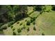 Aerial view of a lush garden, featuring various trees and plants, surrounded by a green lawn at 78 N Pomona Rd, Hampton, GA 30228