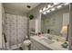Traditional bathroom with shower-tub combo, toilet, vanity with marble countertop and storage at 78 N Pomona Rd, Hampton, GA 30228
