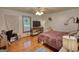 Bedroom with hard wood floors, bed, dresser, ceiling fan, and natural light at 78 N Pomona Rd, Hampton, GA 30228