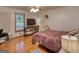 This bedroom with hardwood floors includes a ceiling fan and window for lots of natural light at 78 N Pomona Rd, Hampton, GA 30228