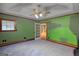The bedroom is ready for renovation and has an exterior door and neutral carpet at 78 N Pomona Rd, Hampton, GA 30228