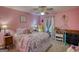 Pink bedroom featuring dolls, decorations and a ceiling fan with carpeted floors at 78 N Pomona Rd, Hampton, GA 30228