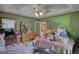Cluttered bedroom area featuring an exterior door, ceiling fan, carpeted floor, and wooden dresser at 78 N Pomona Rd, Hampton, GA 30228