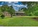 Inviting single-story brick home with a front porch, surrounded by mature trees and greenery at 78 N Pomona Rd, Hampton, GA 30228