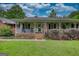 Charming single-story home featuring a welcoming front porch with an American flag at 78 N Pomona Rd, Hampton, GA 30228