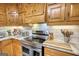 Close up of kitchen featuring wood cabinetry, stainless steel appliances and stone countertops at 78 N Pomona Rd, Hampton, GA 30228
