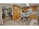 Kitchen featuring wood cabinetry, stainless steel appliances, and an adjacent dining area at 78 N Pomona Rd, Hampton, GA 30228