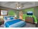 The main bedroom features a blue bedspread, ceiling fan, modern TV and wood dresser at 78 N Pomona Rd, Hampton, GA 30228