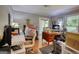 Messy office featuring hardwood flooring, natural light, and outdated decor at 78 N Pomona Rd, Hampton, GA 30228