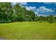 A large, grassy lawn with lush green trees at 78 N Pomona Rd, Hampton, GA 30228