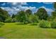 Mature trees provide ample shade to a large, grassy lawn at 78 N Pomona Rd, Hampton, GA 30228