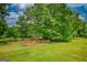 A fenced enclosure sits at the edge of the grassy yard at 78 N Pomona Rd, Hampton, GA 30228