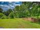 A fenced enclosure sits at the edge of the grassy yard at 78 N Pomona Rd, Hampton, GA 30228