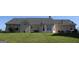 View of the home's exterior showing a well-maintained lawn and neutral-colored siding at 239 Ferguson Ave, Locust Grove, GA 30248