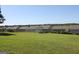 Wide shot of a backyard with a storage shed and neighboring houses at 239 Ferguson Ave, Locust Grove, GA 30248