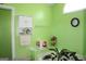 Bright bathroom featuring a built-in shelf unit, towel bar, clock, and indoor plant near a bathtub at 239 Ferguson Ave, Locust Grove, GA 30248