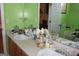 Bright bathroom with a double sink, framed mirror, and views of a bedroom through an open doorway at 239 Ferguson Ave, Locust Grove, GA 30248