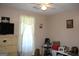 Neutral bedroom with ceiling fan and natural light at 239 Ferguson Ave, Locust Grove, GA 30248