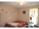 Bedroom features ceiling fan and window with curtain at 239 Ferguson Ave, Locust Grove, GA 30248