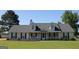 Charming single-story home with a well-manicured lawn and inviting front porch at 239 Ferguson Ave, Locust Grove, GA 30248