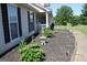 Landscaped yard with a stone garden and walkway leading to the home's entrance at 239 Ferguson Ave, Locust Grove, GA 30248