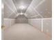 Unfinished attic space with carpet, drywall, and a doorway at 125 Lake Park Dr, Sharpsburg, GA 30277
